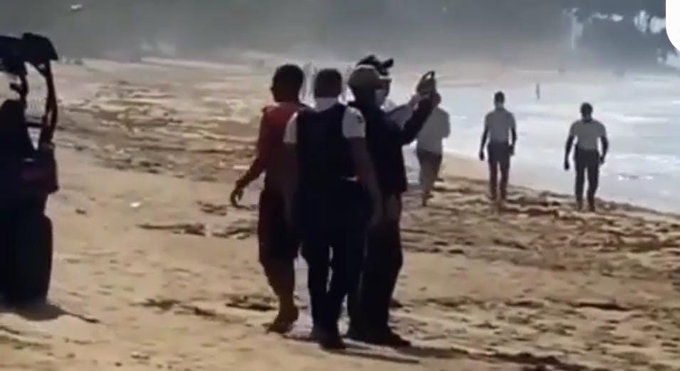 Denuncian policías grababan mientras surfistas recuperaban un cadáver en una playa