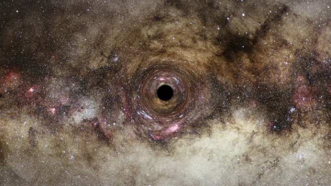 Una lente gravitacional permite descubrir uno de los mayores agujeros negros del universo